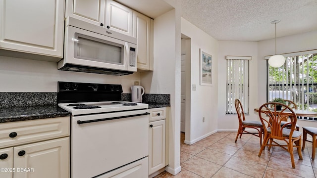 4655 46th Street Ct W Unit 101, Bradenton, FL 34210 - kitchen with white appliances, light tile patterned flooring, decorative light fixtures, a textured ceiling, and dark stone countertops