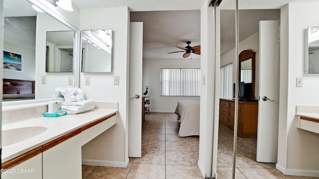 4655 46th Street Ct W Unit 101, Bradenton, FL 34210 - full bath featuring ensuite bathroom, a textured ceiling, vanity, a ceiling fan, and tile patterned flooring