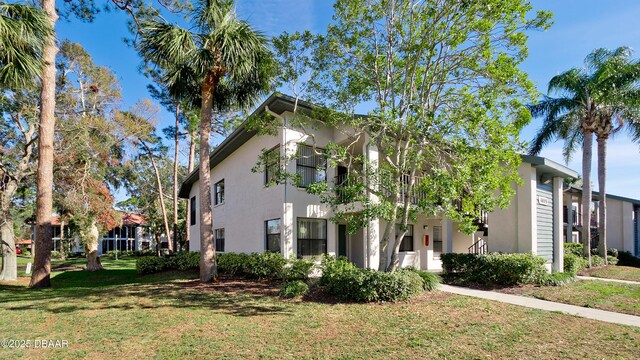 4655 46th Street Ct W Unit 101, Bradenton, FL 34210 - view of side of property featuring stucco siding and a lawn