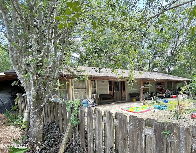 back of property featuring a patio, roof with shingles, and fence