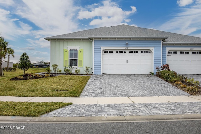 view of front of property with a garage and a front yard