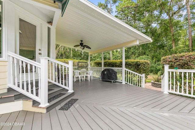 wooden terrace with ceiling fan and a grill