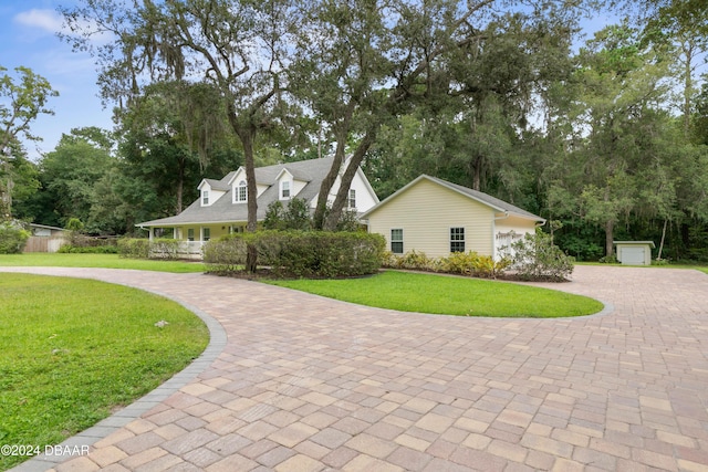 exterior space featuring a porch, a garage, and a front lawn