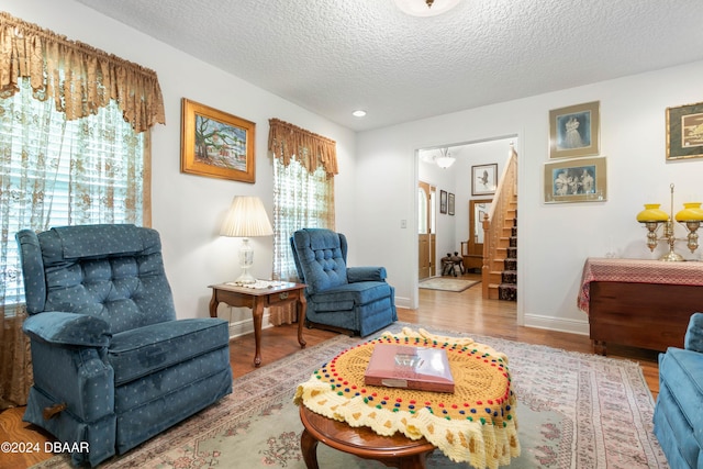 sitting room featuring a textured ceiling and light wood-type flooring