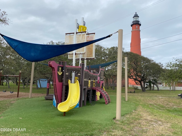 view of playground with a lawn