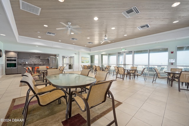 tiled dining room featuring ornamental molding, ceiling fan, and wooden ceiling