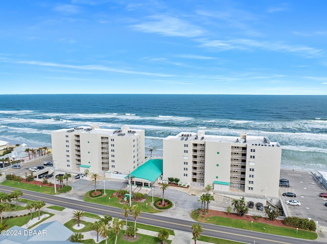 bird's eye view with a water view and a beach view