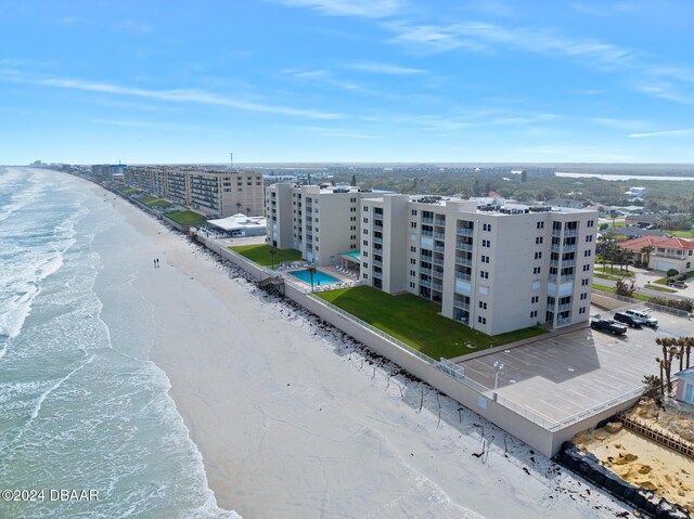 birds eye view of property with a beach view and a water view