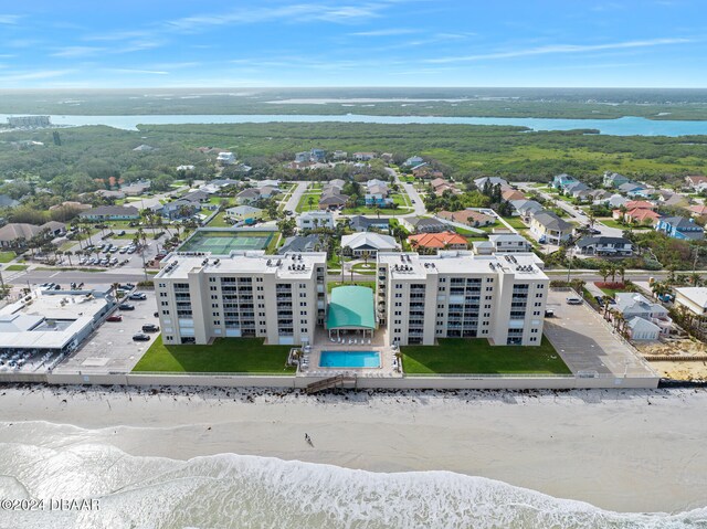 bird's eye view featuring a water view and a beach view