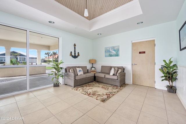 tiled living room with ornamental molding, wood ceiling, and a tray ceiling