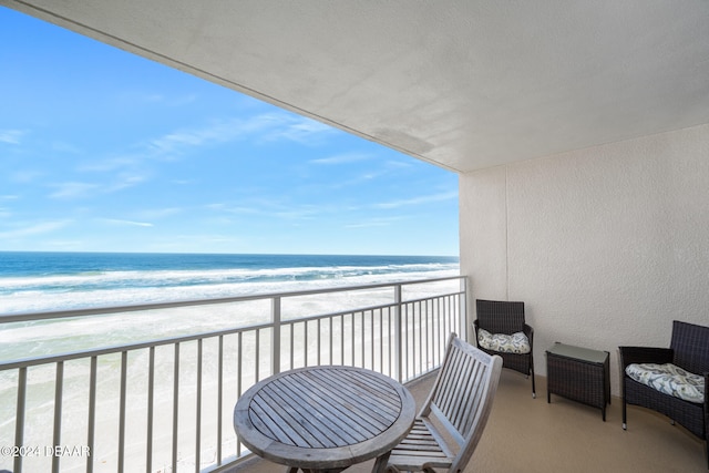 balcony with a beach view and a water view