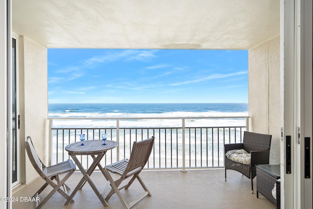 balcony with a beach view and a water view