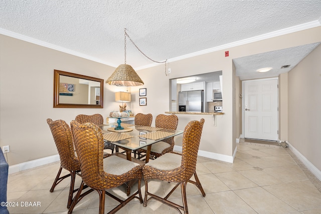 tiled dining space featuring a textured ceiling and ornamental molding