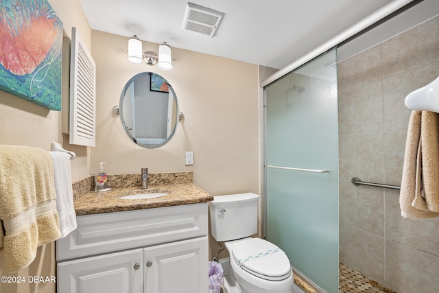 bathroom featuring walk in shower, vanity, and toilet