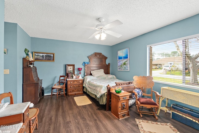 bedroom with ceiling fan, dark hardwood / wood-style floors, and a textured ceiling