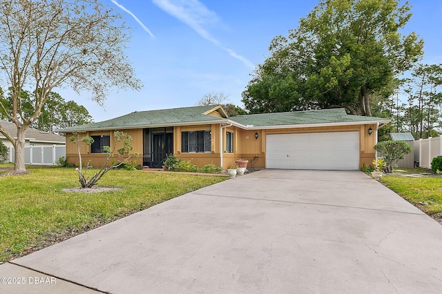 ranch-style home with a garage and a front lawn