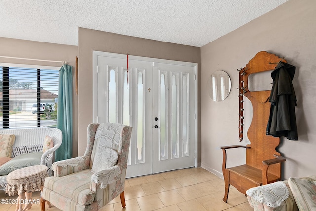 entryway featuring light tile patterned floors and a textured ceiling