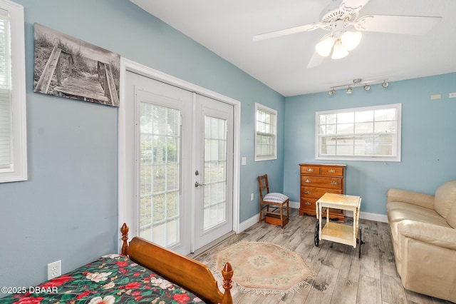 interior space with light hardwood / wood-style flooring, multiple windows, access to outside, and ceiling fan