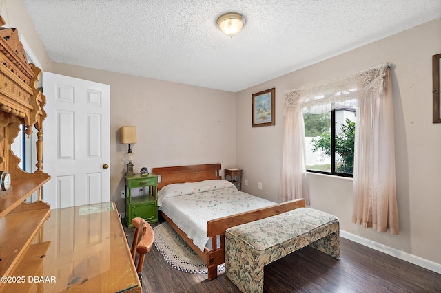 bedroom featuring dark hardwood / wood-style floors and a textured ceiling