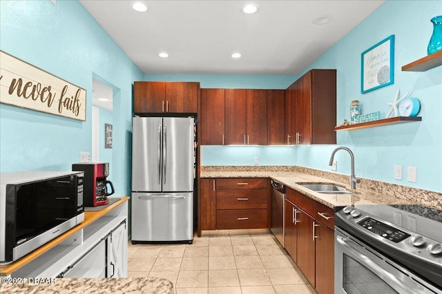 kitchen featuring appliances with stainless steel finishes, sink, and light tile patterned floors