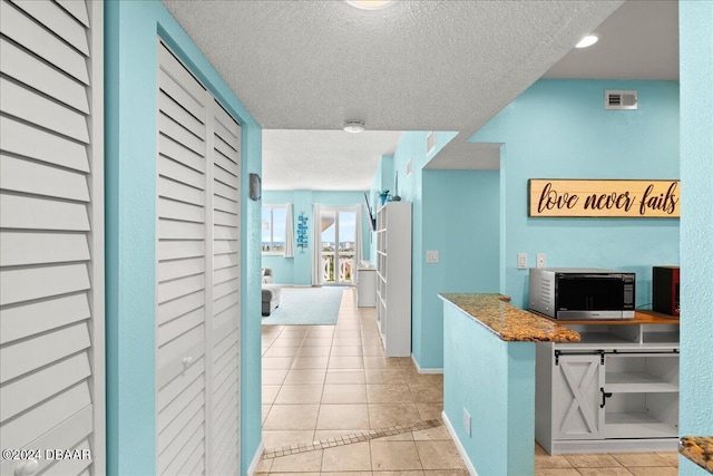 kitchen featuring light tile patterned floors and a textured ceiling