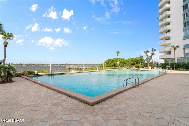 view of swimming pool with a water view