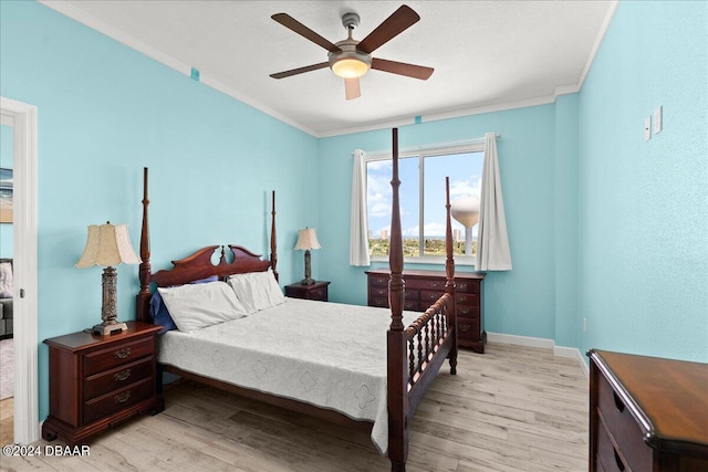 bedroom featuring crown molding, ceiling fan, and light wood-type flooring