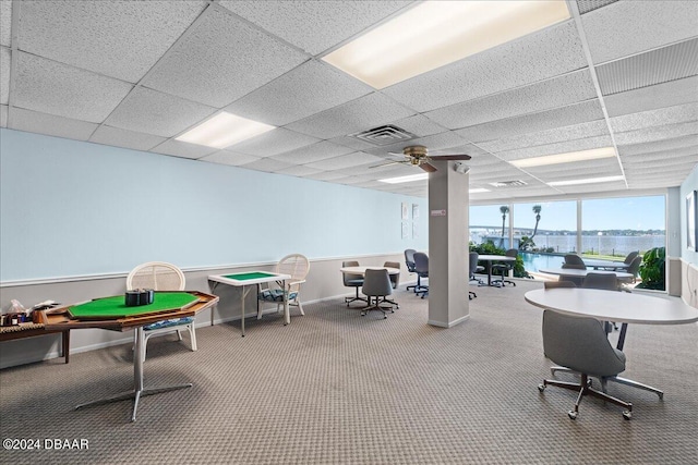 interior space featuring a water view, a paneled ceiling, carpet flooring, and ceiling fan