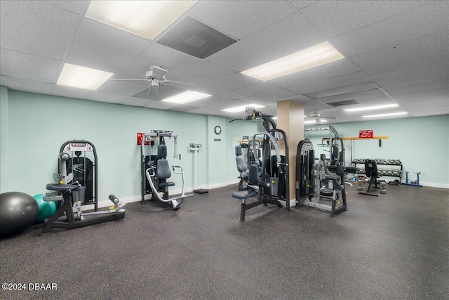 gym with ceiling fan and a drop ceiling