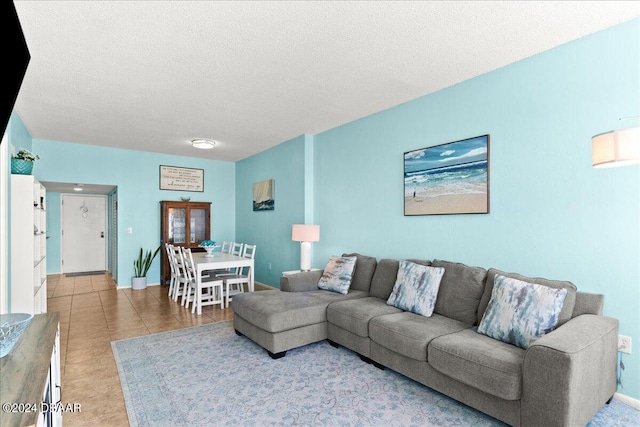 living room featuring tile patterned floors and a textured ceiling