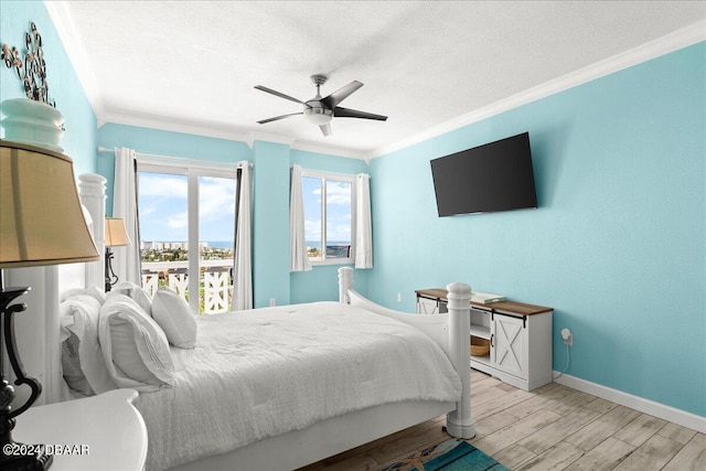 bedroom with ceiling fan, ornamental molding, a textured ceiling, and light wood-type flooring