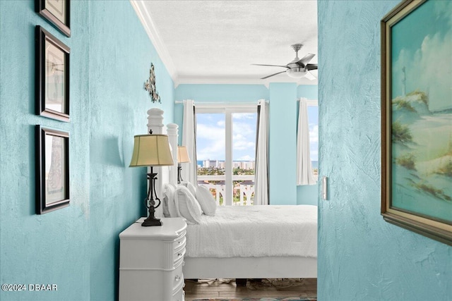 bedroom with crown molding, ceiling fan, wood-type flooring, and a textured ceiling