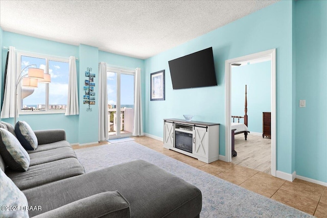 tiled living room with a fireplace and a textured ceiling