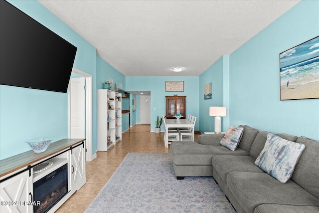 living room featuring light tile patterned floors and a textured ceiling