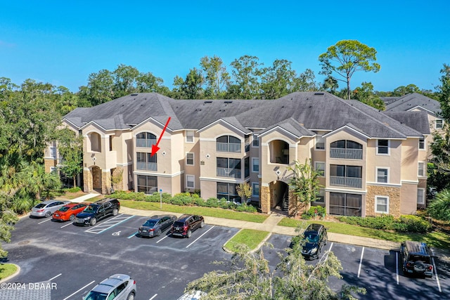 940 Village Trl Unit 3-203, Port Orange, FL 32127 - view of building exterior with uncovered parking