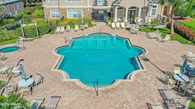 940 Village Trl Unit 3-203, Port Orange, FL 32127 - community pool featuring a patio, french doors, fence, and a hot tub