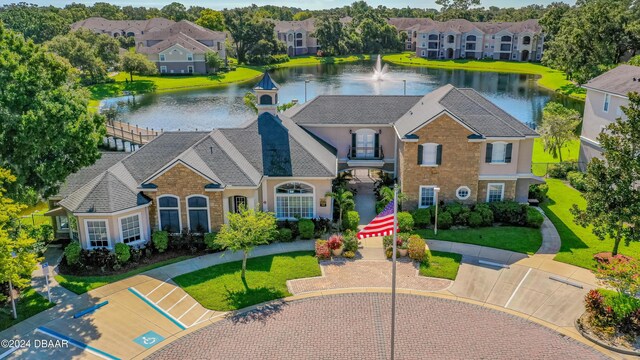 940 Village Trl Unit 3-203, Port Orange, FL 32127 - colonial home with a water view, stucco siding, a front lawn, and a residential view
