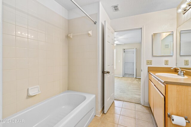 940 Village Trl Unit 3-203, Port Orange, FL 32127 - full bath featuring tile patterned floors, vanity, bathing tub / shower combination, and baseboards