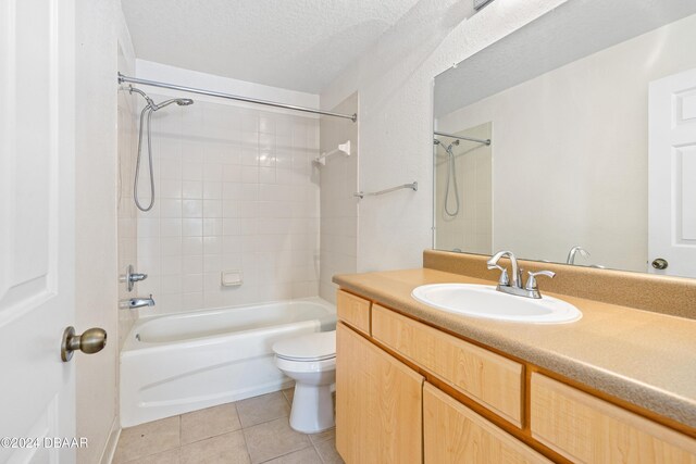 940 Village Trl Unit 3-203, Port Orange, FL 32127 - full bathroom with toilet, tile patterned floors, vanity, shower / bath combination, and a textured ceiling