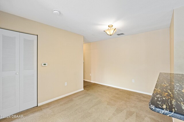 940 Village Trl Unit 3-203, Port Orange, FL 32127 - unfurnished living room with carpet and baseboards