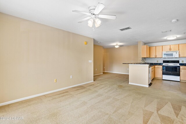 940 Village Trl Unit 3-203, Port Orange, FL 32127 - kitchen with white appliances, open floor plan, light carpet, and baseboards