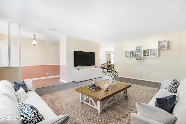 tiled living room featuring a chandelier