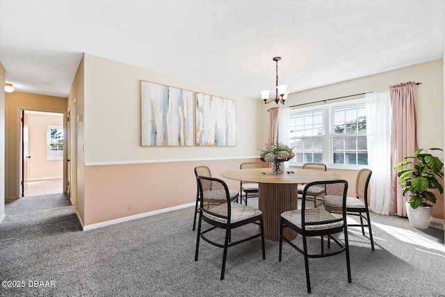 carpeted dining space with an inviting chandelier