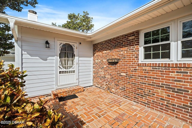 entrance to property featuring a patio area