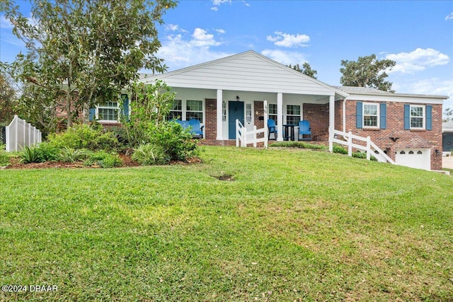 view of front of house with a garage, a porch, and a front yard