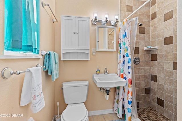 bathroom with sink, a shower with curtain, and toilet