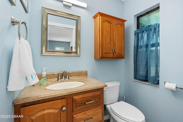 bathroom featuring vanity and toilet