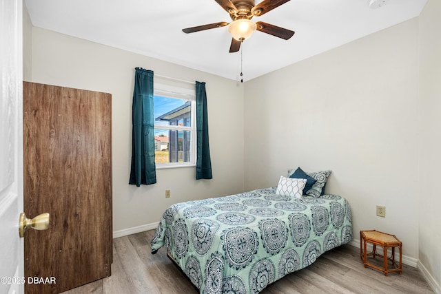 bedroom featuring hardwood / wood-style flooring and ceiling fan