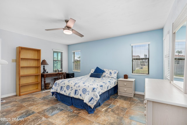 bedroom with multiple windows and ceiling fan