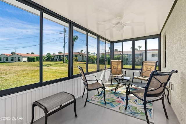 sunroom / solarium featuring ceiling fan